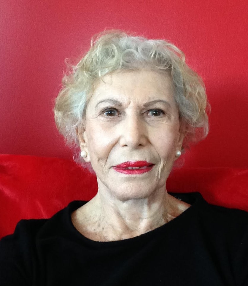 Reinventing in your 80s: picture of Stephanie Schwartz, a silver-haired woman wearing a black top. There is a red background in the picture