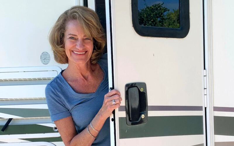 Reinvention after 50 - picture of Michelle Fisbhurne. She is standing with the door open of her RV