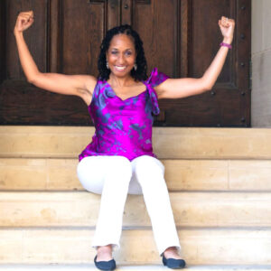 Picture of Wendy Battles sitting on steps make muscles. Embracing fear helps us overcome failure.