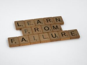 Failure leads to our success. Picture of Scrabble tiles that says "learn from failure" 