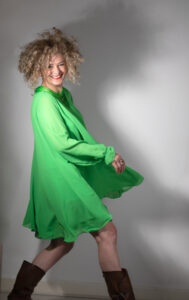 Picture of Guler Cortis in green dress. She is embracing change at 61