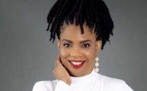Midlife caregiving burdens can be eased with simple organizational tips says professional organizer Janet Taylor, pictured smiling in a white top.