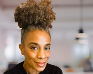 Reinventing looks different for each of us. Picture of Oneika Mays smiling into the camera