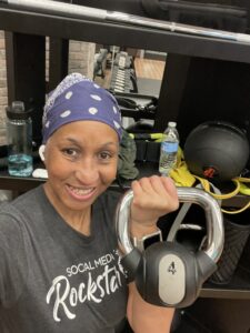 Midlife body in action. Picture of Wendy holidng a kettlebell at the gym.
