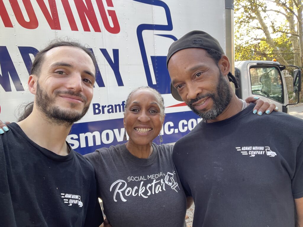 Midlife shows up in so many ways, like moving to a new city when you're 61! Picture of me with my two movers.